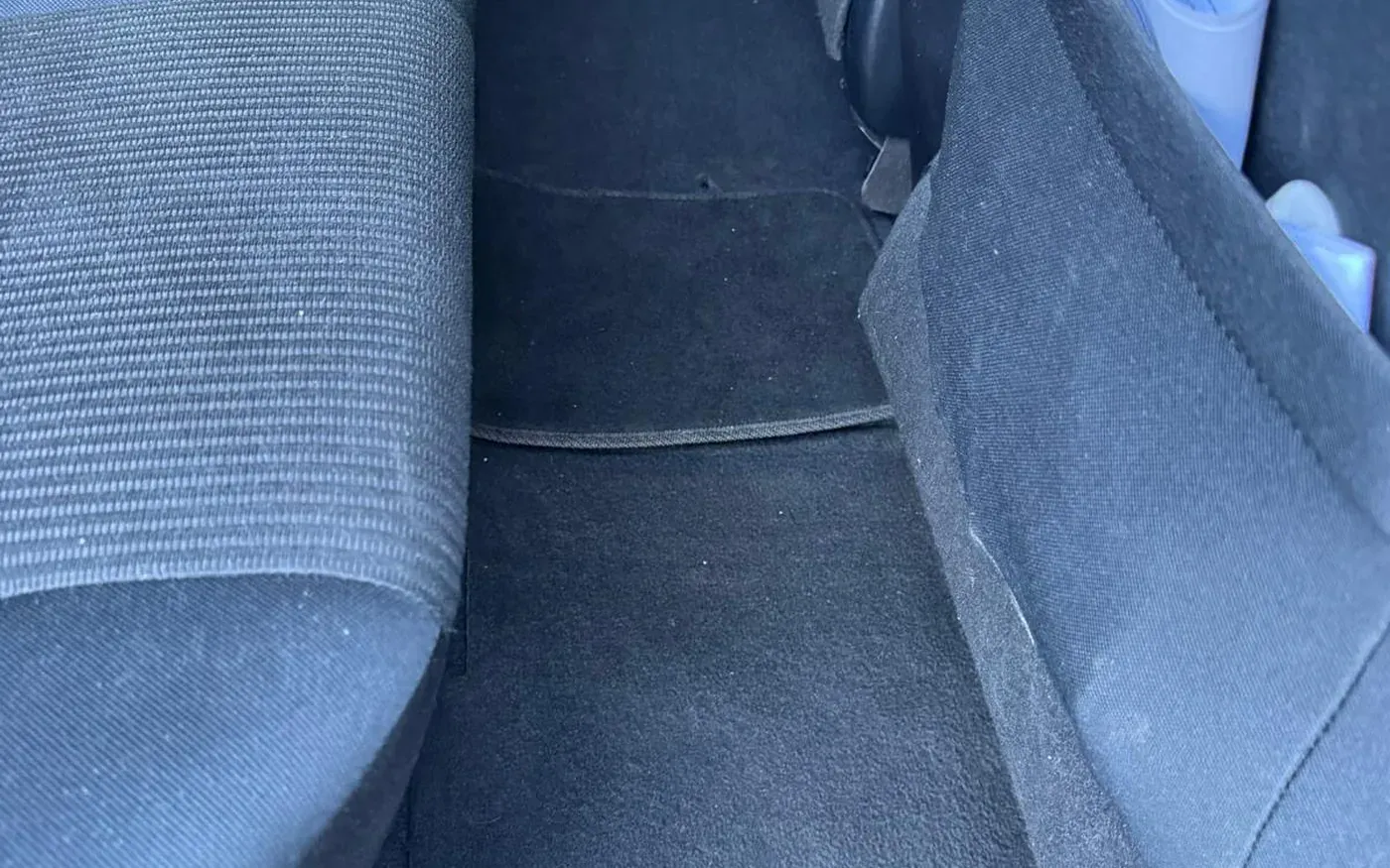 Close-up of car carpet before professional stain removal