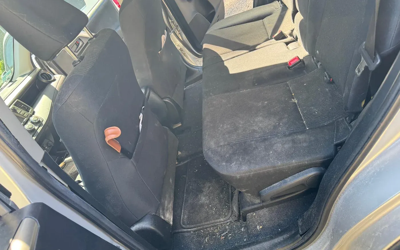 Car rear footwell before deep cleaning and odor removal treatment