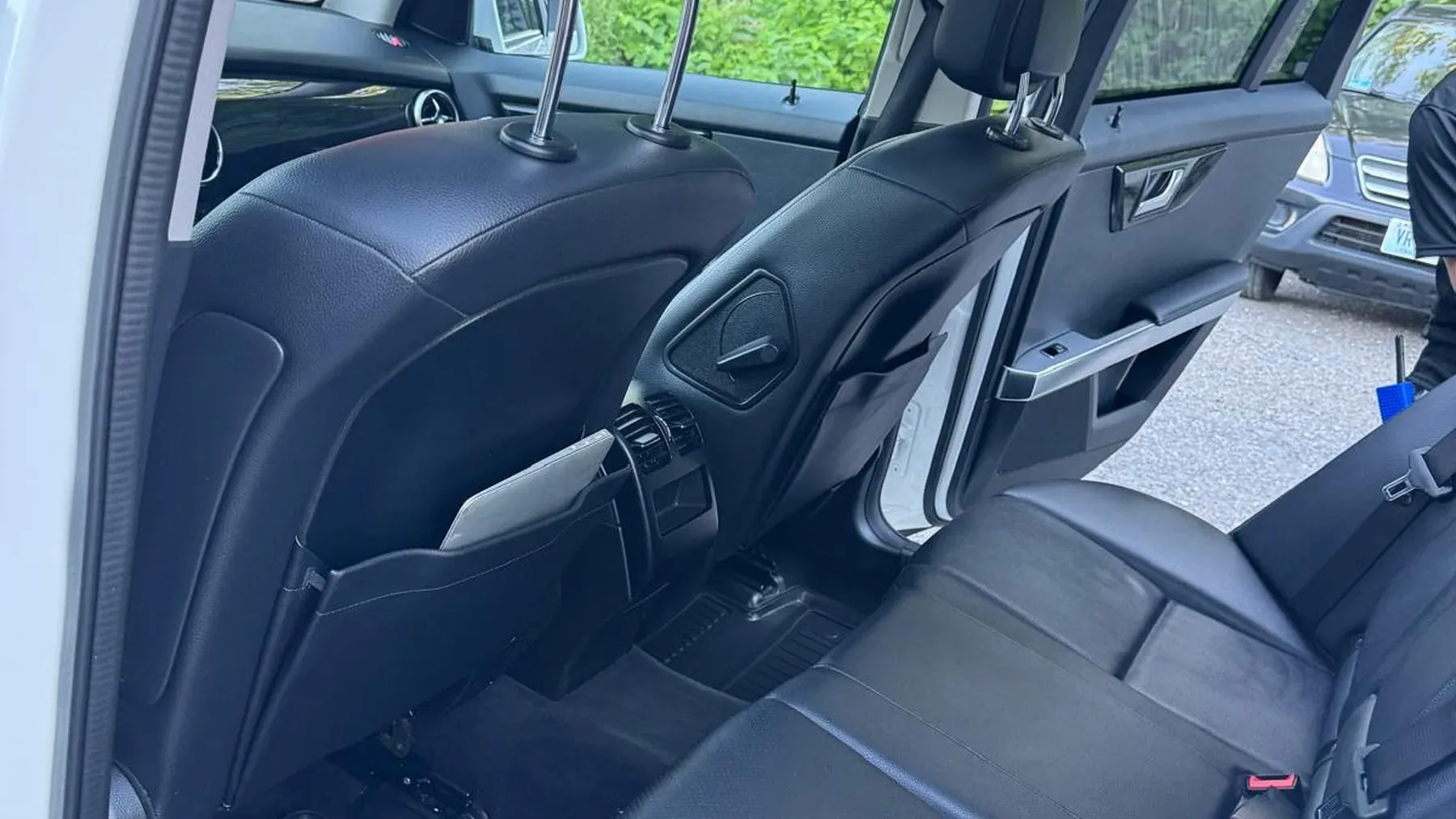 Clean leather car seats and open door after a detailing appointment