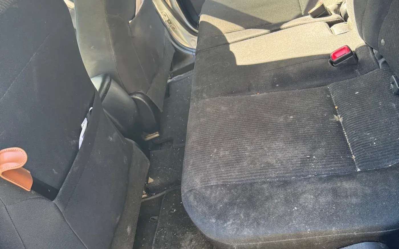 Car interior before professional mobile detailing compared to an automatic wash